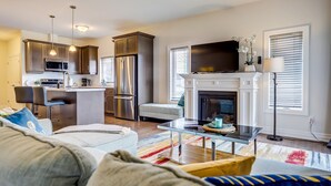 A modern living room with a sofa, a coffee table, and a fireplace. - GLOBALSTAY Brand New House in Port Elgin (Saugeen Shores)