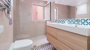 A modern bathroom with a shower, toilet, and vanity. - Cosy 2 bed flat with terrace near Av Liberdade (Lisboa)