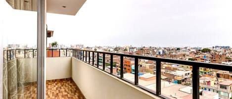 A balcony with a view of a cityscape.