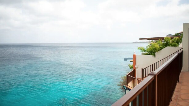A coastal balcony with a view of the turquoise sea and a distant shoreline. - Villa at Playa Lagun Private Beach Curaçao (Curaçao)