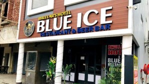 The exterior of Blue Ice Restaurant & Beer Bar, featuring a modern facade with a prominent sign and potted plants in front. - Hotel Bhullar (Amritsar)