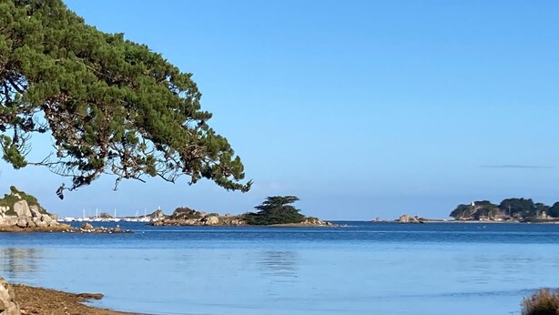A coastal beach with rocky terrain and a clear blue sky. - Simple Bonheur (Penvénan)