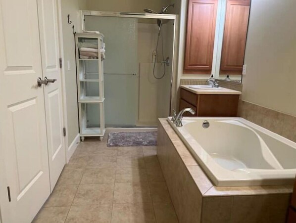 A bathroom with a bathtub, a shower, and a sink. - A20-Golf Course River View Unit Sunserra near pool Gorge shuttle book separately (Quincy)