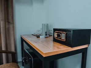 Cozy retreat with a wooden table, comfortable seating area, and a safe for secure storage.