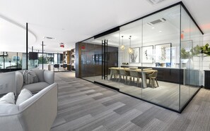 Enjoy a productive work session in this modern office space with a comfortable lounge area and natural light.