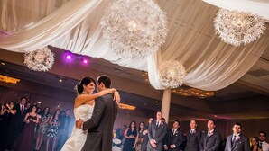 A wedding reception with a couple dancing, surrounded by guests in formal attire. - Reading Vitality Hotel (Wyomissing)
