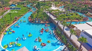 A large indoor swimming pool with multiple lanes and people using inflatable rings.