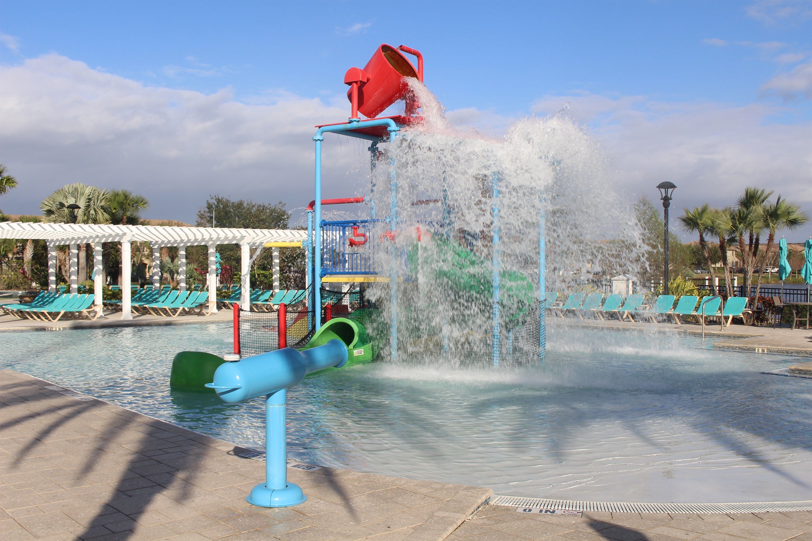 A water play area with a water slide and a water fountain.