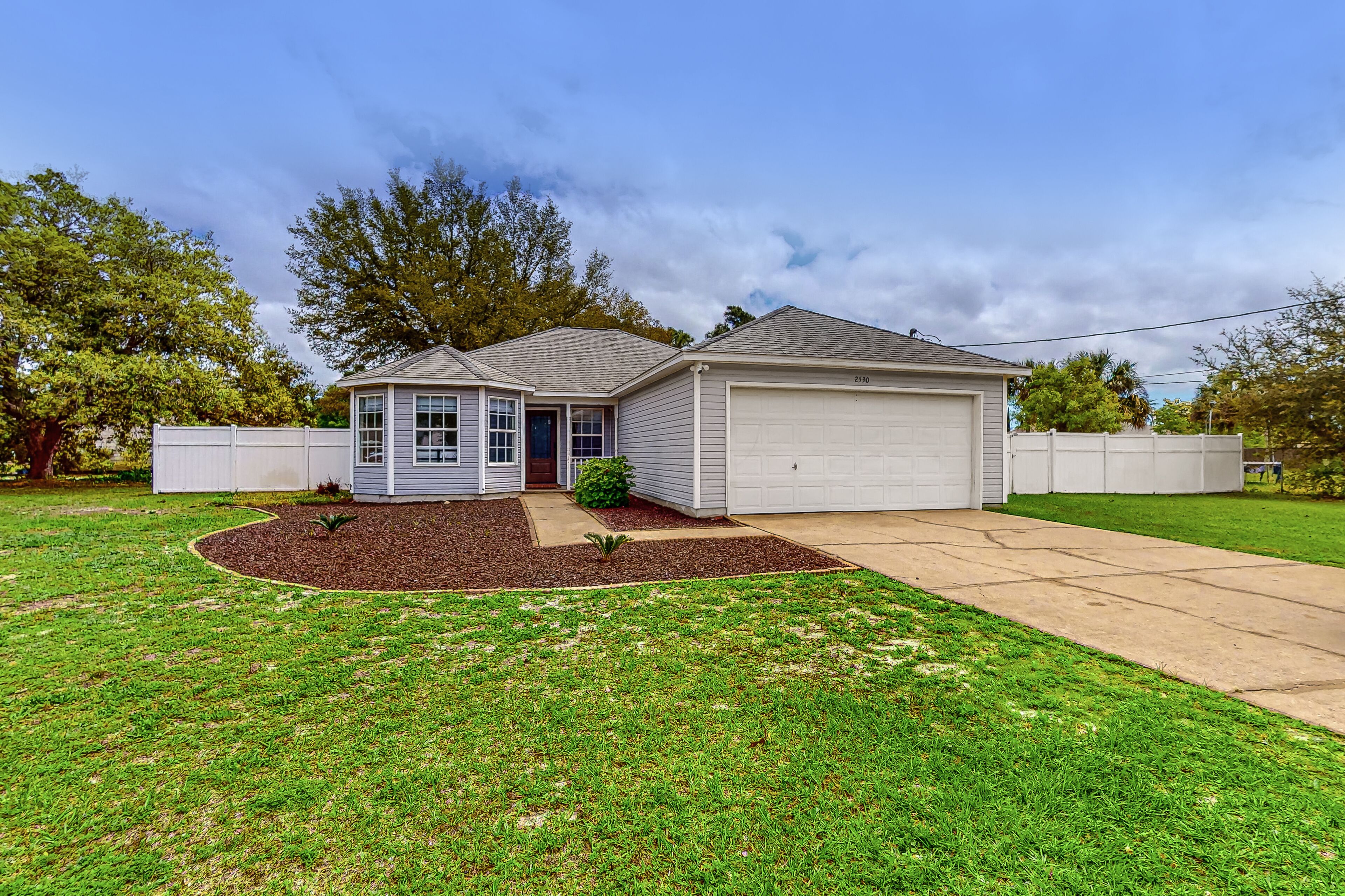 Dog-friendly home with fenced yard, grill, central AC, & washer/dryer