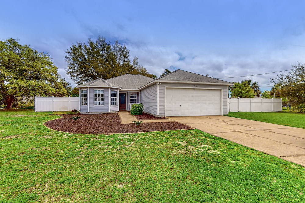 Dog-friendly home with fenced yard, grill, central AC, & washer/dryer