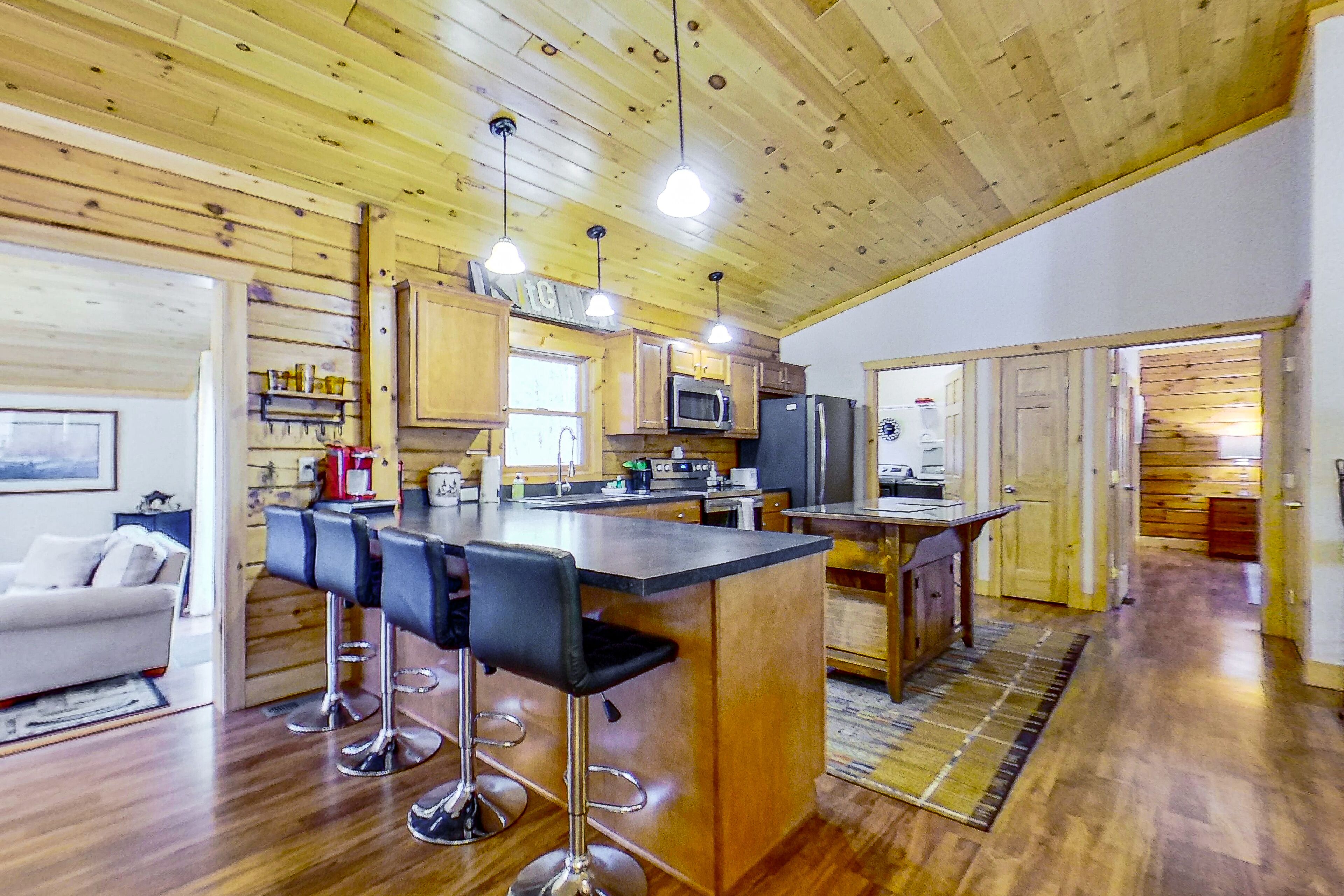 Riverfront dog-friendly home with firepits, dock, wood stove, & beach