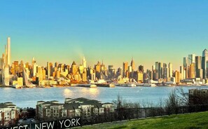 A city skyline with the text "NEW YORK" visible. - Charming 3BHK - 15 mins bus ride to Time Sq., NYC (West New York)
