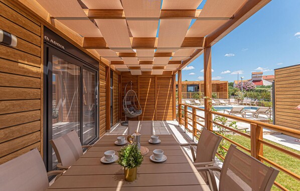 Relax on the deck with lounge chairs and a hanging chair, perfect for dining or socializing.
