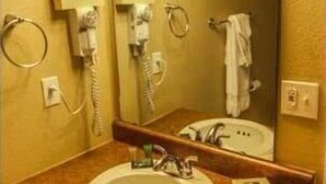 A bathroom with a sink, mirror, and towel rack. - Capital Vacations Carriage Place - 1 Bedroom (7-Night) (Branson)