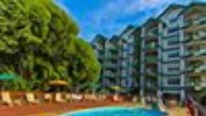 Una piscina rodeada por un edificio con varios balcones.