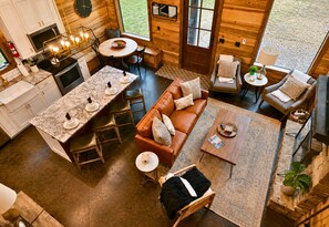 A modern interior with a kitchen, dining area, and seating space.