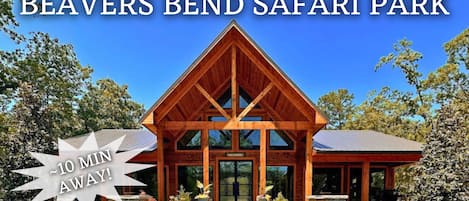 A wooden lodge with a prominent gabled roof and a welcoming entrance.