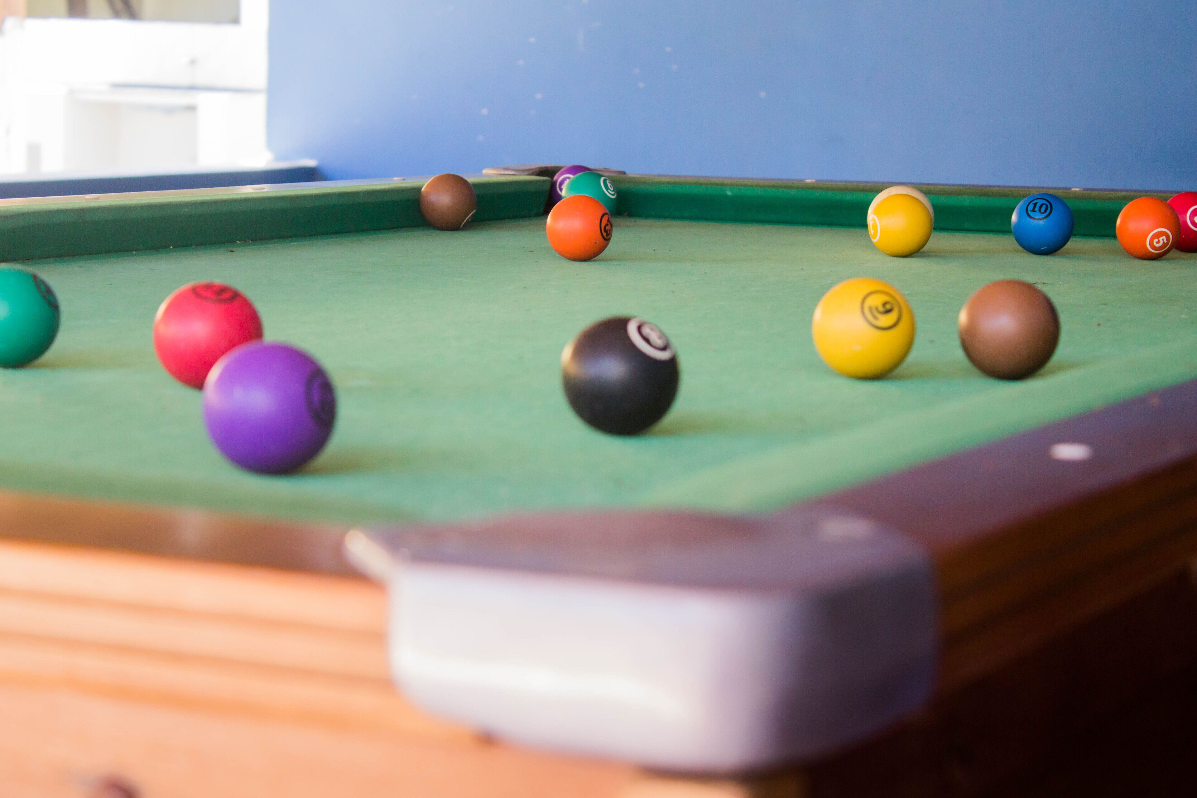 A pool table with various colored balls.