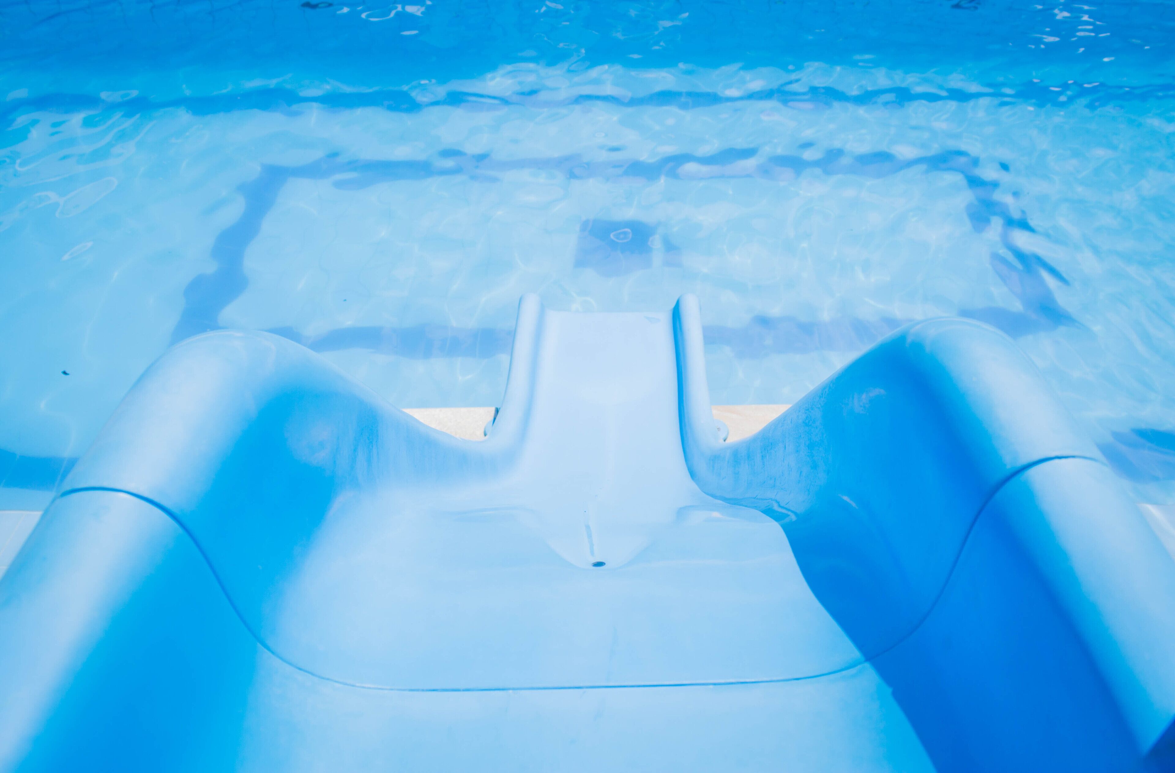 A pool with clear blue water and a floating chair.