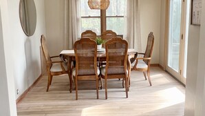 A dining area with a wooden table and chairs, a hanging light fixture, and a sign reading "Stratton Lake". - Waterfront Paradise! Boat available for rent. (Waupaca)