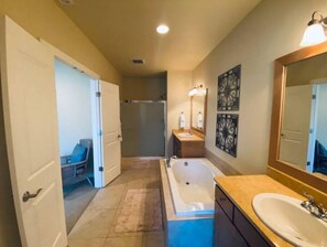 A bathroom with a bathtub, a sink, and a shower.