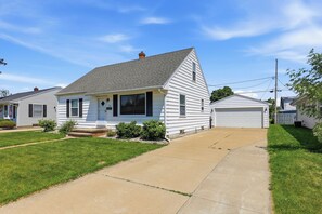 A single-story house with a front porch, a garage, and a well-maintained lawn.