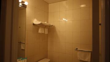 A bathroom with a toilet, a sink, and a towel rack.