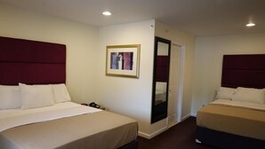 A hotel room with two beds, a large mirror, and a framed picture on the wall. - The Hamlet Inn at Warwick (Warwick)