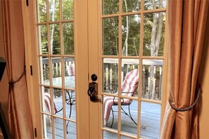 Step outside to a deck with a table and chairs.