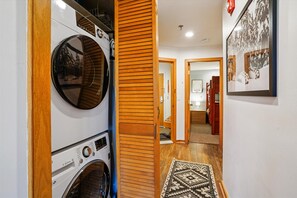 In-Unit Washer & Dryer - Convenient stacked washer and dryer tucked into the hallway for easy use during your stay. - Your Highridge Haven E1 (Killington)