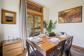 Dining Space with Balcony Access - Bright dining area for four with large windows and sliding doors leading to the private balcony. - Your Highridge Haven E1 (Killington)