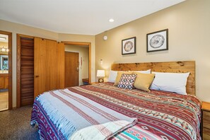 Inviting King Retreat - King bedroom featuring warm wood accents, bedside lighting, and a relaxing layout.