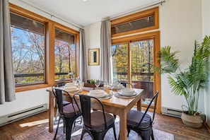 Dining with a View - Dine surrounded by natural light and scenic forest views, with easy access to the private balcony just steps away.
