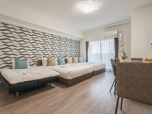 A modern hotel room with a patterned wall, two beds, a seating area, and an air conditioning unit. - ESLEAD HOTEL Namba Ebisu West (Osaka)