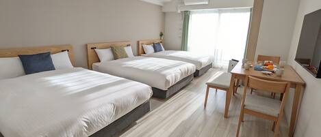 Habitación triple Deluxe | Ropa de cama de alta calidad y cortinas blackout
