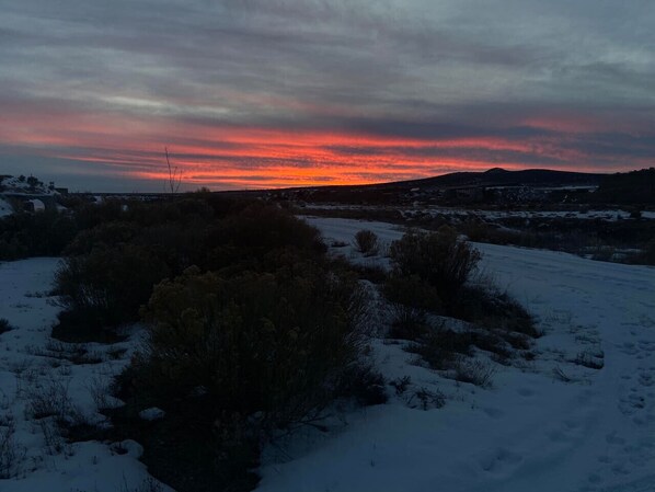 A snowy landscape with a sunset.