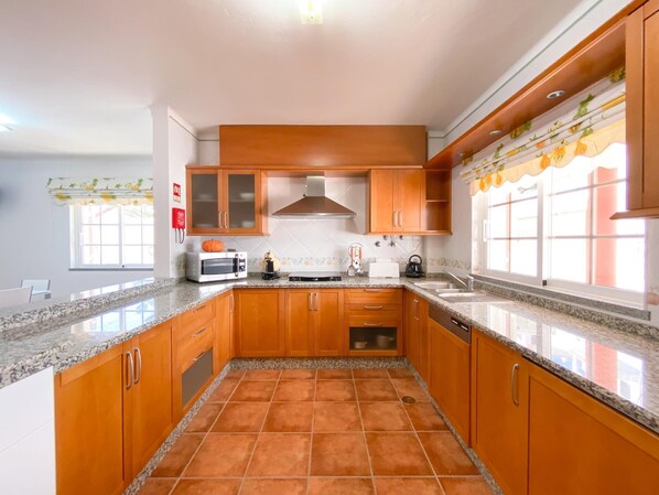 Enjoy cooking in this well-equipped kitchen with an oven, microwave, and toaster.