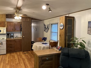 Enjoy meals in this well-equipped kitchen, which leads to a dining area with a table and chairs.