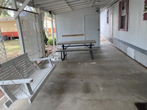 Relax in this serene outdoor space with a bench and picnic table.