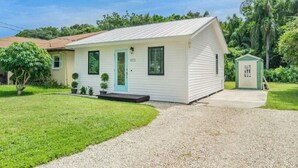 A single-story house with a front porch, a small attached garage, and a well-maintained lawn.