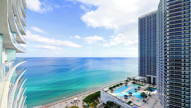 A high-rise hotel with a pool area, beach access, and ocean views. - Family 2BR | Beach Access | Sleeps 6 (Hollywood)