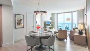 A modern dining area with a round table, four chairs, and a pendant light. - Family 2BR | Beach Access | Sleeps 6 (Hollywood)