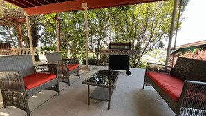 An outdoor patio with wicker furniture and a barbecue grill. - Private 1BR Suite w Full Kitchen & Laundry (Hayward)