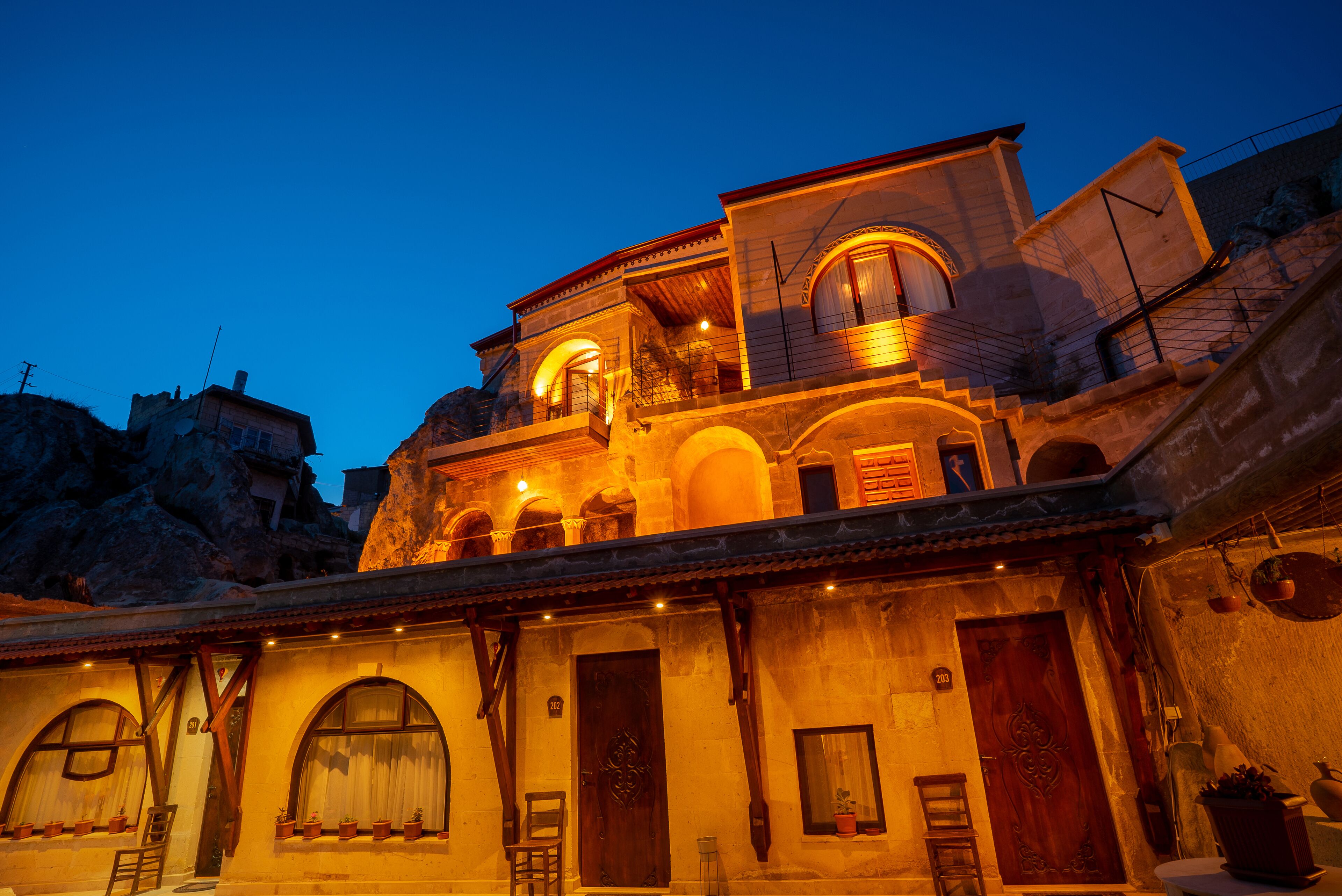 A traditional building with multiple levels, arched windows, and a balcony.