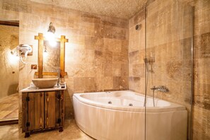 Deluxe Suite | Bathroom | Designer toiletries, hair dryer, slippers, towels