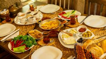 A table set for a meal with various dishes, utensils, and a woven placemat.