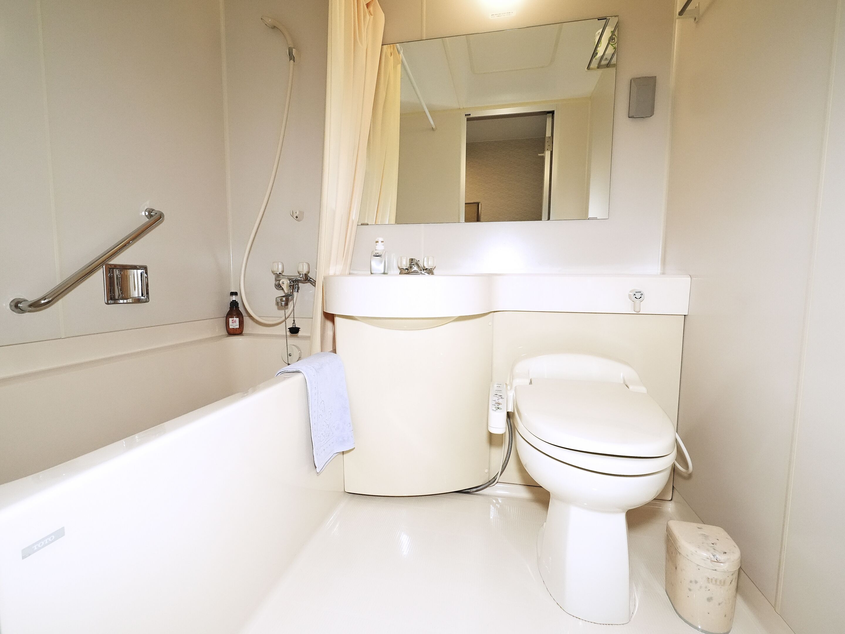 A bathroom with a bathtub, toilet, and sink.