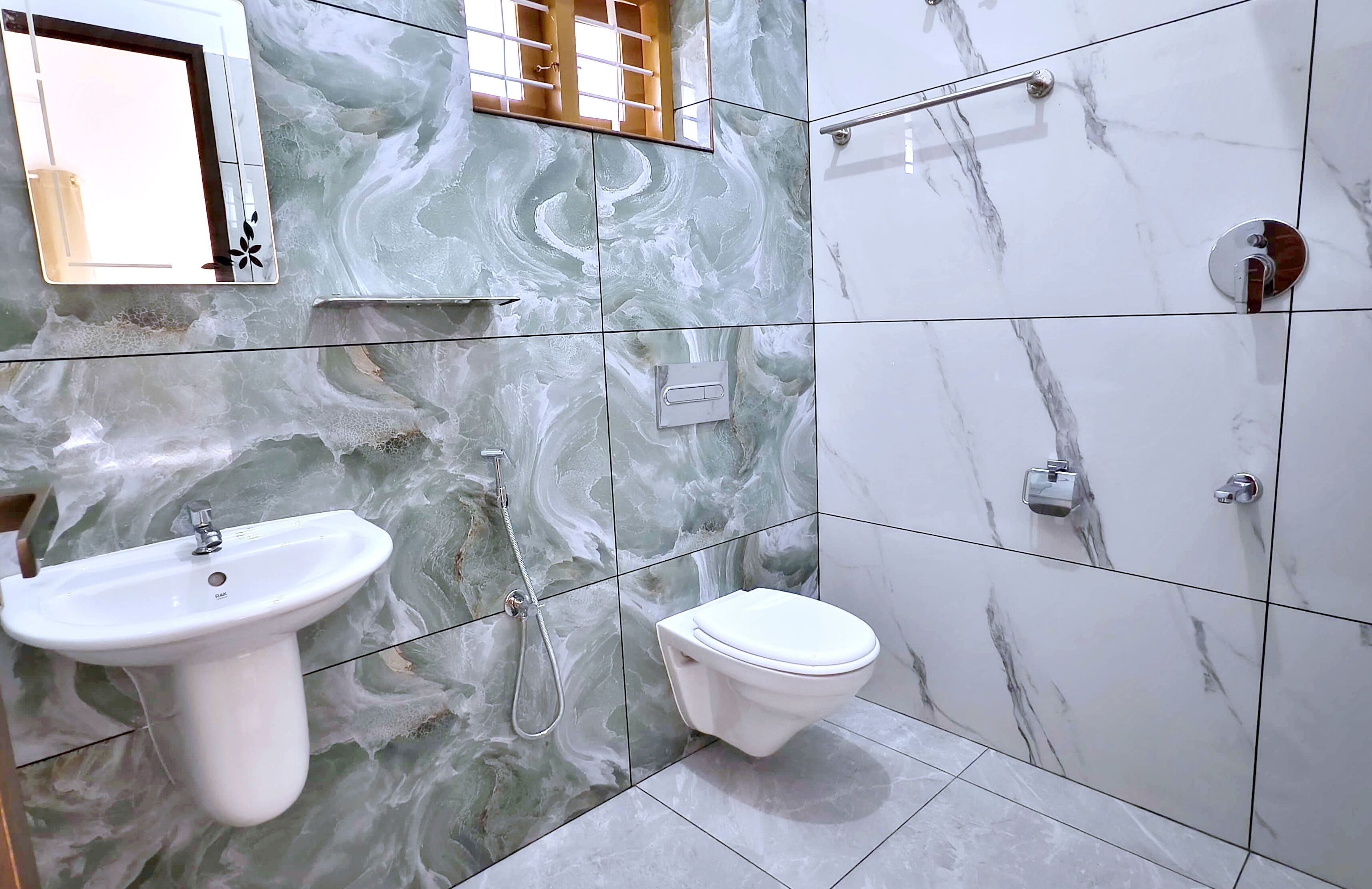 A bathroom with a marble sink, toilet, and shower.