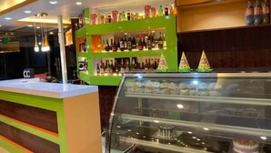 A bakery counter with a glass display case containing cakes and pastries. - Sindhuligadhi Mountain Resort (Ratanchura)