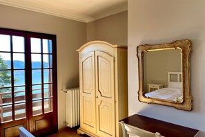 A room with a large window, a wardrobe, a mirror, and a radiator. - Romantic House by Lake Maggiore with Garden (Trarego Viggiona)